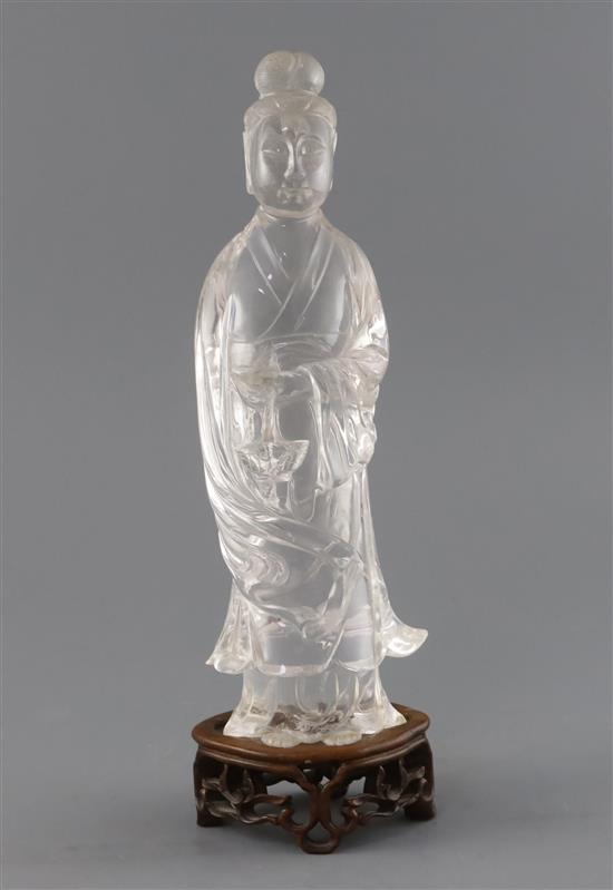 A Chinese rock crystal figure of Guanyin, late 19th century, H.27cm, wood stand